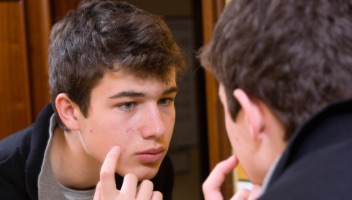 Young male looking at skin