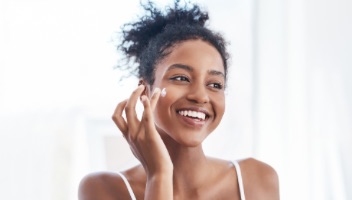 Woman applying face cream