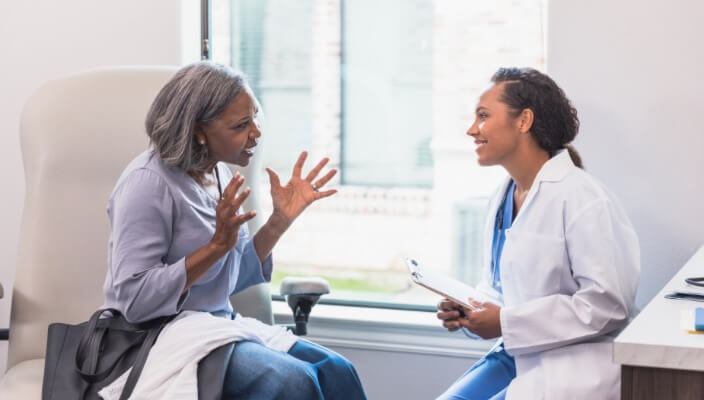 woman talking to dermatologist