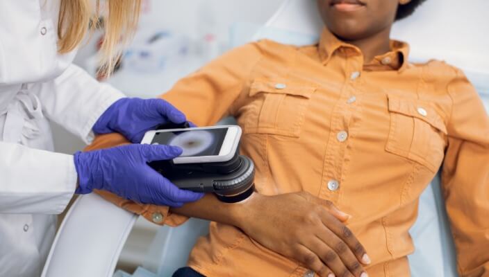 African american man getting a skin exam)